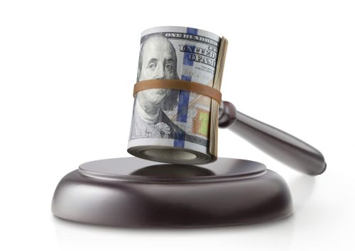 Justice and money. Judge gavel with roll of dollar banknotes on white background.