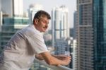 Expat man on balcony thinking about Tax Cuts and Jobs Act